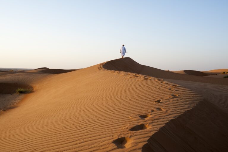 Omani man walking on dunes © Ministry of Heritage & Tourism Sultanate of Oman copy 2